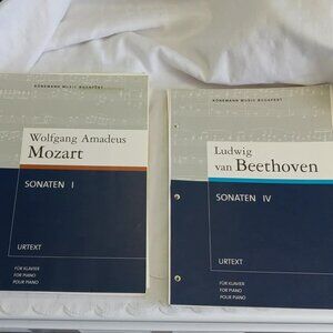 Two music books with the binding removed and three holes for ring binders